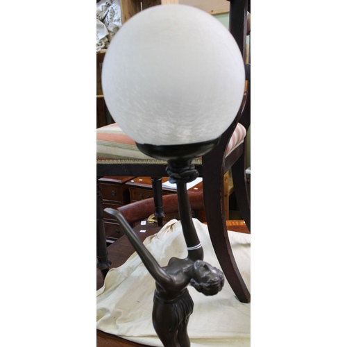 333 - An Art Deco design figurative table lamp, modelled as a bronzed lady, supporting an opaque crackle g... 