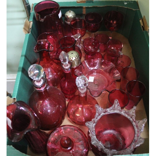 390 - A collection of cranberry glass, includes jug decanters, vases, sugar casters, tumblers, stemmed win... 