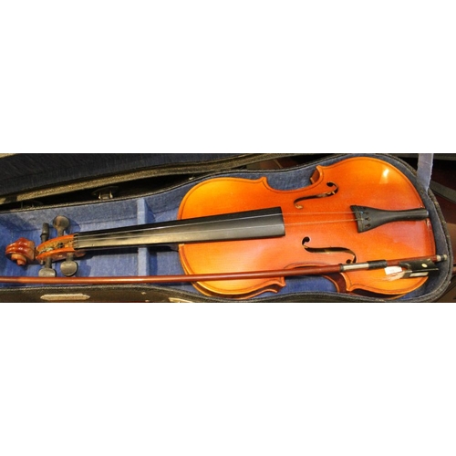 419 - A collection of three violins in cases