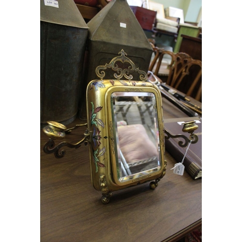 43 - A late 19th century gilt metal vanity mirror, having enamel decoration to the frame, fitted candle s... 