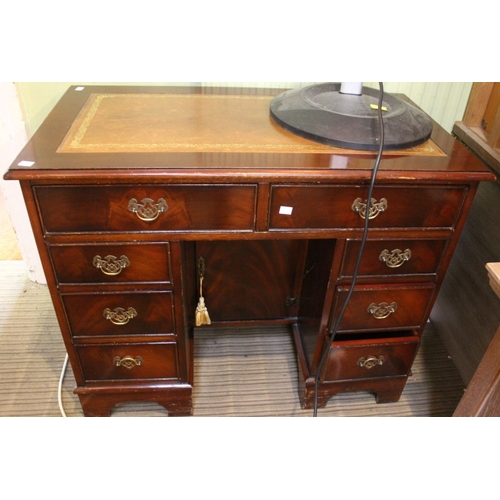 68 - A small knee hole twin pedestal desk, two long over six small drawers. Inset leather skiver top