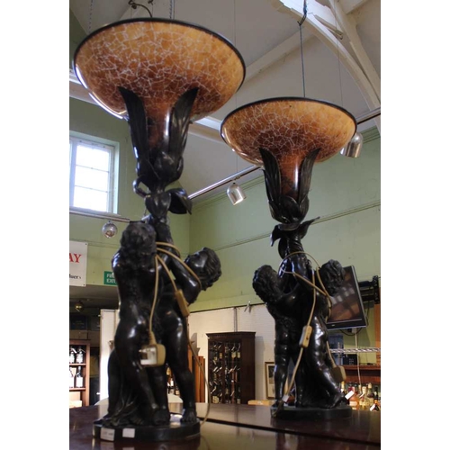 341 - An impressive pair of French bronzed effect table lamps, formed as three putti supporting a flower, ... 