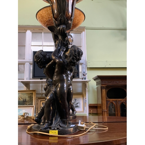 341 - An impressive pair of French bronzed effect table lamps, formed as three putti supporting a flower, ... 