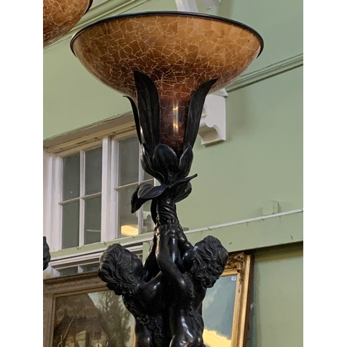 341 - An impressive pair of French bronzed effect table lamps, formed as three putti supporting a flower, ... 