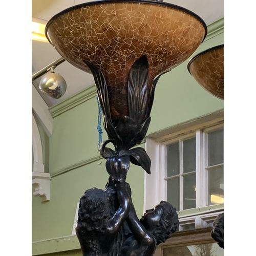 341 - An impressive pair of French bronzed effect table lamps, formed as three putti supporting a flower, ... 