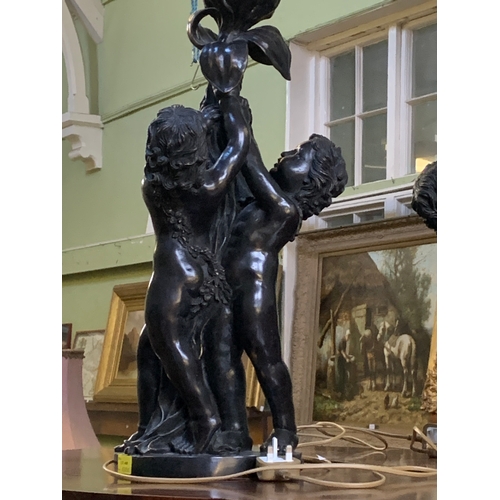 341 - An impressive pair of French bronzed effect table lamps, formed as three putti supporting a flower, ... 