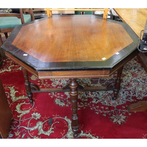 344 - An octagonal occasional table / dining table on four supports with casters