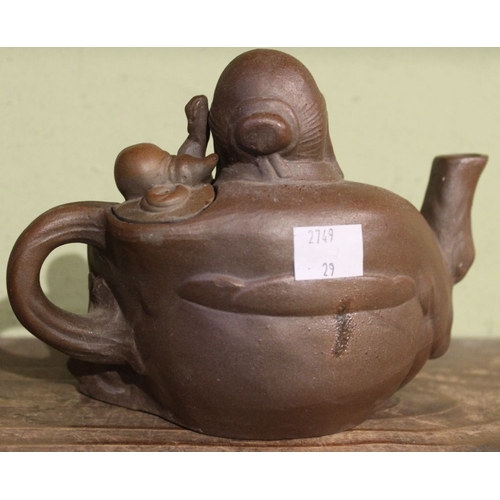 91 - A Chinese stoneware teapot modeled as a God of Plenty