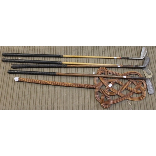 107 - Four hickory shafted golf clubs and a carpet beater