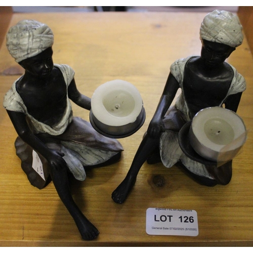 126 - A pair of cast and painted bronze seated Blackamoor night light holders, 12cm high (2)