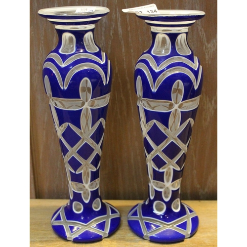 134 - A pair of baluster glass vases, over laid and cut, blue cased, 26cm high