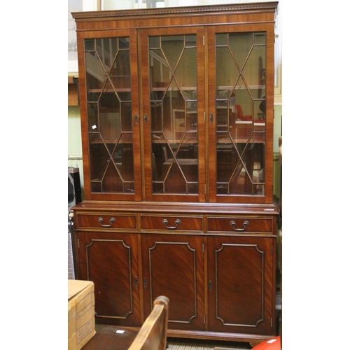 156 - A Georgian design mahogany veneer, breakfront bookcase, glazed upper door over base fitted three dra... 