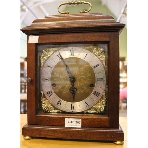 207 - Comitti London - An oak cased mantle clock