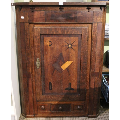 208 - A George III oak hanging corner cupboard, single door inlaid with Masonic symbols