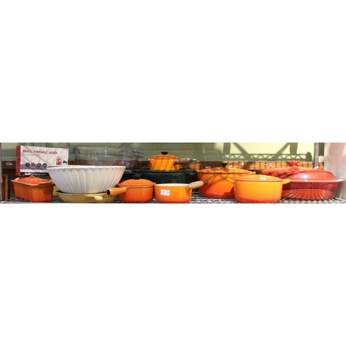 216 - A set of Le Creuset cooking vessels, seven orange, one red & a yellow griddle pan