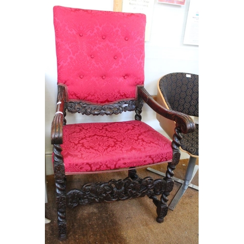 231 - A Carolean oak open arm chair with carved decoration and red fabric upholstered seat and back