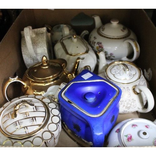 241 - A box containing a selection of teapots, various makers