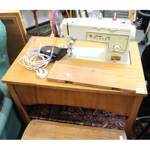 254 - An electric Singer Stylist sewing machine with incorporated table