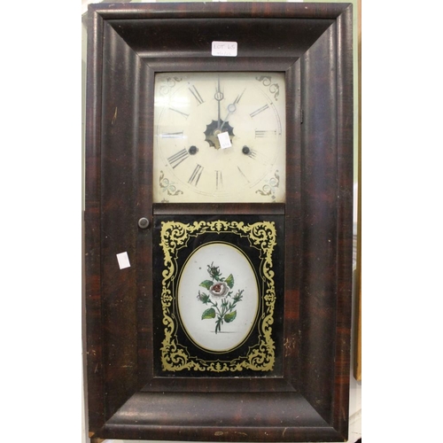 65 - An early 20th century wall clock with decorative tin panel