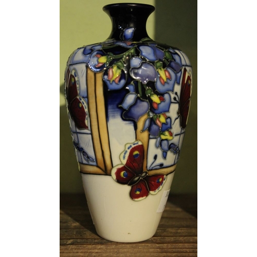 79 - A Moorcroft pottery vase, Wisteria Flutter design, various factory marks to base, 16cm high