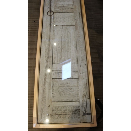 149 - A Moroccan panel, set into a beech framed coffee table with glazed top, 152cm x 49cm