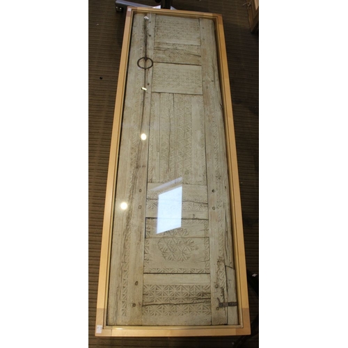 149 - A Moroccan panel, set into a beech framed coffee table with glazed top, 152cm x 49cm