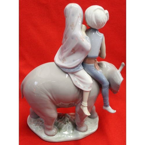 204 - A Lladro figure group, two Indian children riding an elephant 23cm high