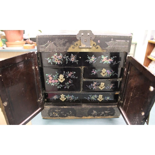 220 - An Oriental ebonised table cabinet, mother of pearl inlaid figurative decoration, with metal fitting... 