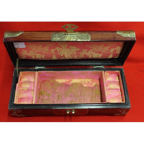 251 - A Chinese jewellery box, with brass and pierced stone decoration, fabric lined, 25cm wide