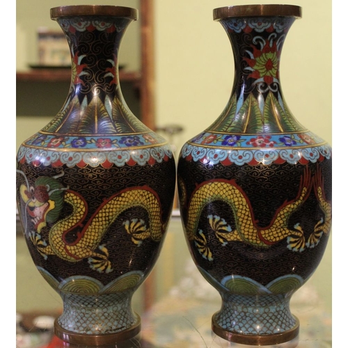 264 - A pair of Chinese cloisonné vases, ebonised bodies with dragons chasing the fiery pearl 23cm high (2... 