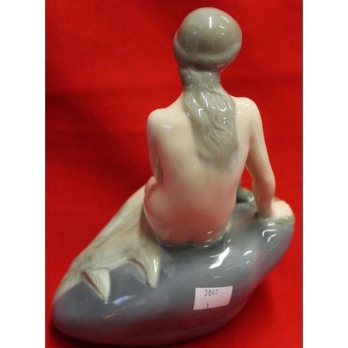 271 - A Royal Copenhagen signed figurine of a mermaid sitting on a rock, signed to the rear Edvard Erickse... 