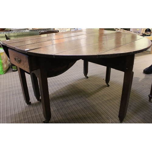 301 - A George III oak oval drop leaf table, fitted a drawer at each end, 123cm x 147cm with leaves up