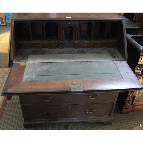 318 - A George III oak fall front writing bureau, fitted four graduated drawers with brass handles, raised... 