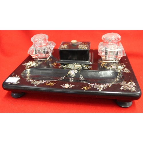 334 - A 19th century papier mache writing stand, with mother-of-pearl inlay fitted two glass inkwells, in ... 