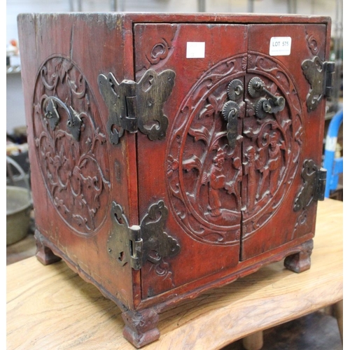 575 - A Chinese table cabinet, red paint effect with carved decoration & decorative metal mounts, 32cm wid... 