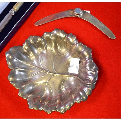 13 - An embossed silver dish in the form of a leaf, Birmingham 1972, 74g, together with a silver handled ... 