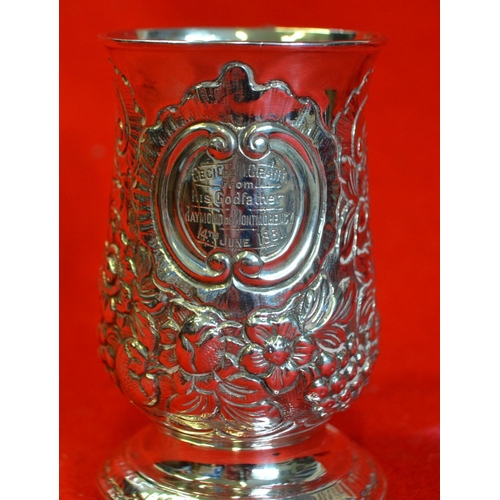 3 - A George III silver Christening mug, with embossed decoration, bears presentation inscription from 