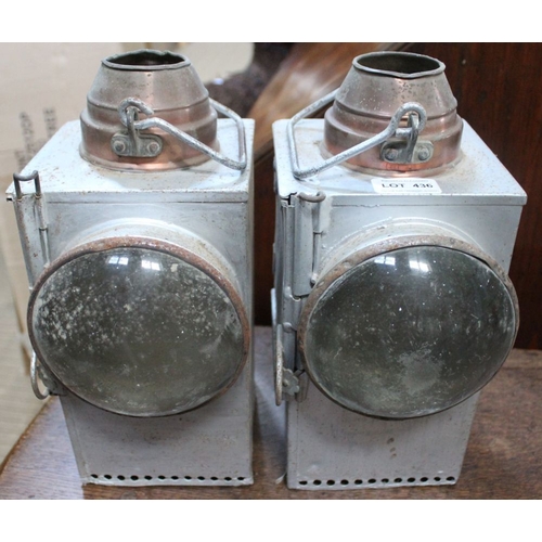 436 - A pair of tin lanterns, embossed SR, with clear lenses, later aluminium painted