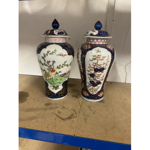 40 - Pair of oriental porcelain urns & lids