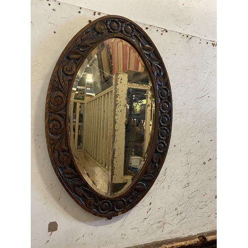 673 - Edwardian oak oval mirror