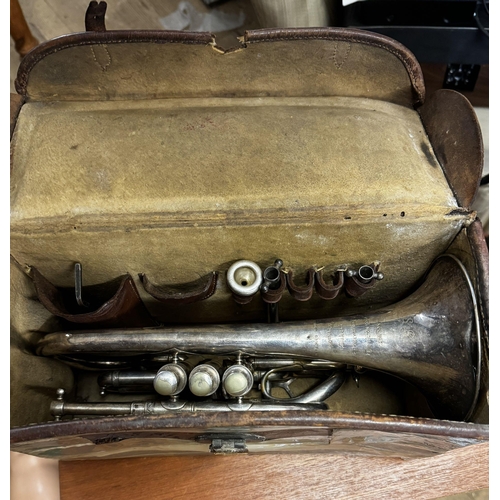 64 - Cased trumpet