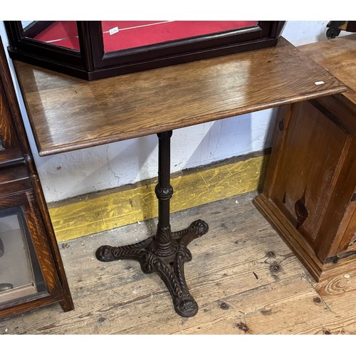 215 - Cast iron based table with a polished oak top