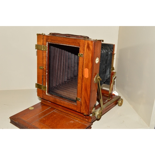 405 - A THORNTON PICKARD PLATE CAMERA, with mahogany case and brass adornments and fitted with a Rectoplan... 