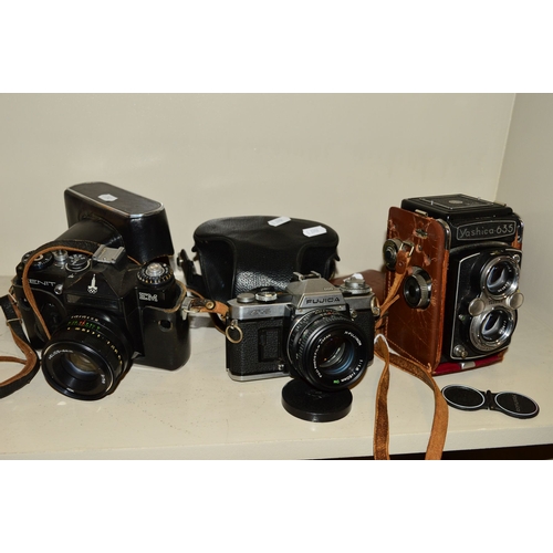 488 - A YASHICA 635 TRL CAMERA, fitted with 80mm f3.5 lenses, a Zenit EM fitted with Helios 58mm f2 lens a... 