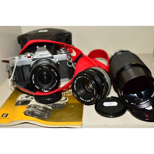 490 - A CANON AV-1 FILM SLR CAMERA, fitted with a Sigma 28mm f2.8 lens, a Canon FD 50mm f1.8, a Vivitar 75... 