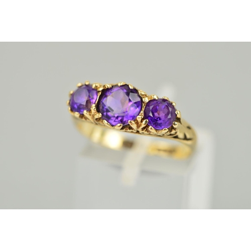 37 - A MID TO LATE 20TH CENTURY THREE STONE AMETHYST RING, scroll detail to shoulders and sides, ring siz... 