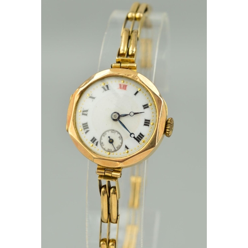 49 - AN EARLY 20TH CENTURY 9CT GOLD LADY'S WRISTWATCH, white enamel dial with Roman numerals and seconds ... 