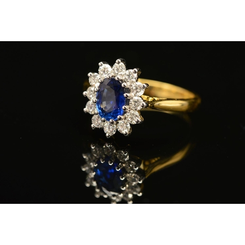 1 - A MODERN 18CT GOLD SAPPHIRE AND DIAMOND OVAL CLUSTER RING, oval blue sapphire measuring approximatel... 