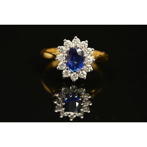 1 - A MODERN 18CT GOLD SAPPHIRE AND DIAMOND OVAL CLUSTER RING, oval blue sapphire measuring approximatel... 