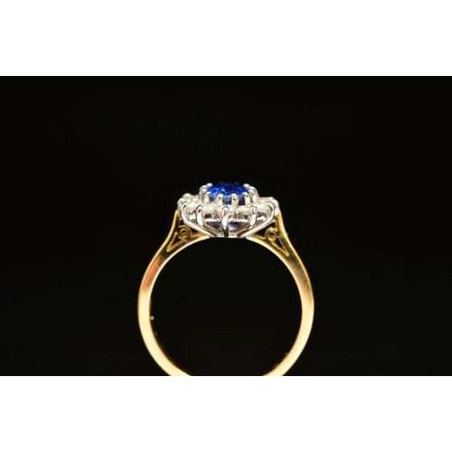 1 - A MODERN 18CT GOLD SAPPHIRE AND DIAMOND OVAL CLUSTER RING, oval blue sapphire measuring approximatel... 